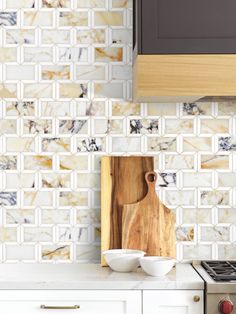 a wooden cutting board sitting on top of a kitchen counter