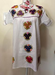 a white dress with colorful flowers on it