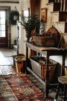 the entryway is decorated with baskets and plants