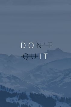 the words don't quitt are displayed in front of snowy mountains and trees