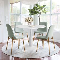 a white table with four chairs around it