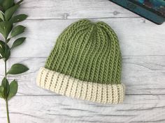 Sage green and cream hand knitted hat made from 100% pure wool (merino and shetland).  Our hats are pure wool so are naturally breathable and help control your temperature so you don't get too hot or too cold.  We sell a wide range of different colour hats. Please find our full range here: https://www.etsy.com//shop/TheDorothyDays?ref=listing-shop-header-item-count&section_id=20861918 We believe in beautiful, practical and long lasting items which are unique, a joy to own and will be treasured for many years to come.  || Features || - Sage green and Natural Shetland (cream)  - Designed to fit snug to your head - 100% wool  - Available with or without a pom pom  - Pom pom (if requested) will be in 'Natural Shetland', an undyed cream yarn as standard. If you require a matching pom instead pl Green Knitted Winter Hat, Winter Soft Knit Green Hat, Green Cozy Beanie For Outdoor Use, Green Soft Knit Winter Hat, Winter Green Soft Knit Hat, Cozy Green Beanie For Outdoors, Cozy Green Beanie For Outdoor, Cozy Green Winter Hat, Green Cozy Beanie One Size Fits Most