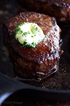 steak with butter and broccoli on top in a frying pan, ready to be eaten