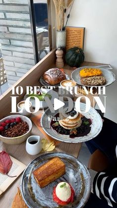 a table topped with lots of different types of foods and desserts next to a window