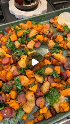 a pan filled with potatoes and greens on top of a stove