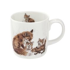 a coffee cup with three foxes on it