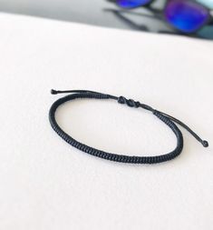 Simple Braided Bracelet Waxed Cord, Gift for Friends MATERIAL 🔹 Waxed Nylon Cord 🔹 Easy to put on and adjust with the adjustable sliding closure. Standard women size 6 - 7.5 inches Standard men size 6.5 - 8 inches All items are handmade with love just for you! 🔹 Check out our shop for more anklets https://www.etsy.com/shop/JustSeedBeads?ref=seller-platform-mcnav§ion_id=23857241 Thank you! Minimalist Adjustable Friendship Bracelets, Simple Black Bracelets As Gift, Simple Black Bracelets For Gift, Simple Black Bracelets For Gifts, Simple Black Bracelet For Gift, Minimalist Black Friendship Bracelets For Everyday, Modern Adjustable Braided Bracelets For Everyday, Everyday Nylon Cord Bracelet, Handmade Black Nylon Cord Bracelets