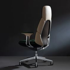 an office chair with black and white upholstered back rests against a dark background