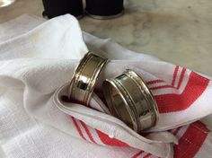 two wedding rings sitting on top of a towel