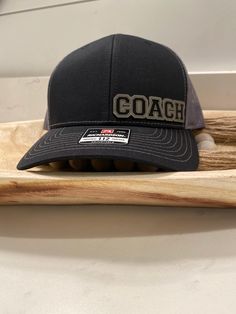 Upgrade your style with the COACH Hat, featuring a sleek gray leather design. The Richardson 112 fit ensures optimal comfort, making it perfect for your favorite coach on and off the field. Stay cool and stylish while showing your support. Coach Hat, Black Hat With Leather Patch, One Size Fits Most, Doll Hat, Grey Leather, Leather Design, Doll Toys, Action Figures, Doll Clothes, Halloween Shopping