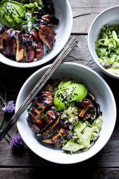 three white bowls filled with different types of food and chopsticks next to each other