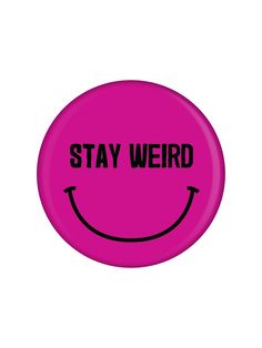 a pink button with the words stay weird on it and a smiley face drawn in black