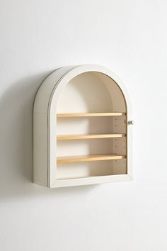 a white wall mounted shelf with two open shelves on the front and one empty shelf in the back