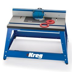 the kreg table sawing machine is blue and has red scissors on it