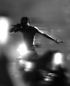 black and white photograph of a person on a skateboard in the air with his arms outstretched