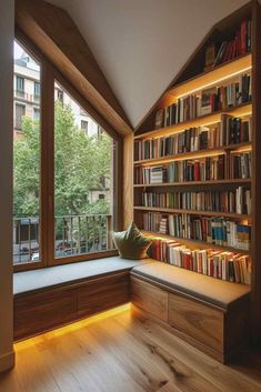 a window seat in front of a book shelf filled with books