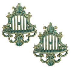 two green metal wall shelves with ornate designs on each shelf and the top one is open