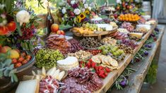 a table filled with lots of different types of food on top of wooden boards next to each other