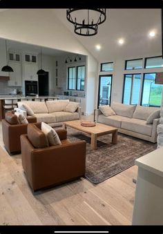 a living room with couches and chairs in it's open floor plan area