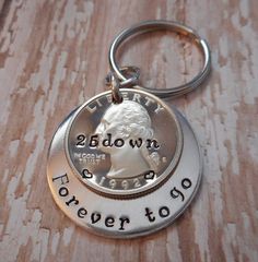 a coin keychain with the words down and forever to go on it