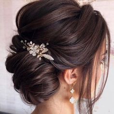 a woman wearing a hair comb with flowers on it's head and pearls in her hair