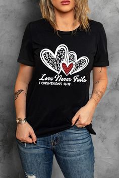 Black Love Never Fails Leopard Sequin Heart Graphic Valentines Tee Black Graphic Print Top For Valentine's Day, Black Graphic Tee For Valentine's Day, Black T-shirt With Heart Graphic For Valentine's Day, Black Crew Neck Top With Heart Print, Black Short Sleeve T-shirt With Heart Print, Black Crew Neck T-shirt With Heart Print, Black Heart Print Top For Valentine's Day, Black Cotton Tops For Valentine's Day, Black Graphic Tee With Heart Print