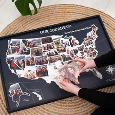 a person holding up a photo collage in front of a black frame with the map of the united states on it