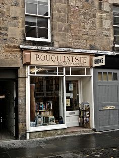 an old brick building with books on the front and windows that read bouquiniste