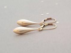 "These earrings are simple and perfect for everyday wear. Long 14k gold filled teardrops hang from your choice of ear wires. Teardrops are concave on the backside. Total length is 1 1/2\" on leverbacks (slightly shorter of french wires) Items will arrive safely packaged on an earring card in an air tight bag, and with an organza bag, ready for gift giving. If you would like a gift box instead, please let me know. Please let me know if you have any questions!" Gold Minimalist Teardrop Earrings With Lever Back, 14k Gold Filled Elegant Teardrop Earrings, Elegant 14k Gold-filled Teardrop Earrings, Minimalist 14k Gold Filled Teardrop Dangle Earrings, Nickel-free 14k Gold Filled Teardrop Earrings, Gold Long Drop Teardrop Earrings For Everyday, Dainty Teardrop Earrings With 14k Gold Filled, Everyday Gold Long Drop Teardrop Earrings, Dainty 14k Gold-filled Teardrop Earrings