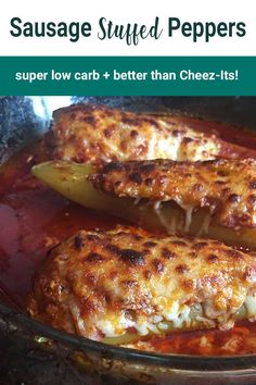 two stuffed peppers in a glass dish with sauce and pepper on the side, text reads sausage stuffed peppers super low carb + better than cheez - it's