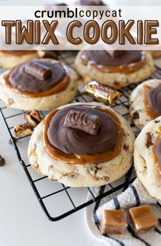 chocolate covered cookies cooling on a wire rack with caramel and pecans in the background