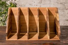 a wooden business card holder sitting on top of a table