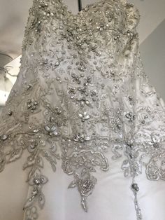 the back of a wedding dress hanging on a hanger