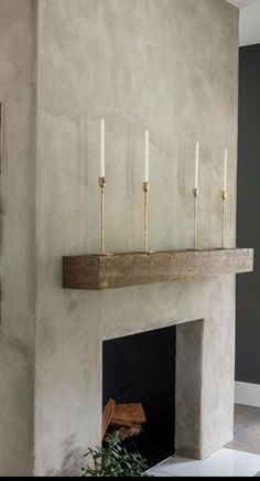 a fireplace with candles on it in a living room