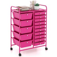 a pink cart with lots of drawers on it and some pens in the top drawer