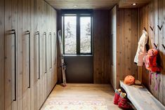 a hallway with wooden walls and wood flooring