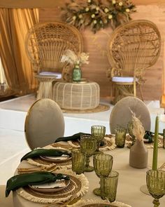 the table is set with plates and glasses