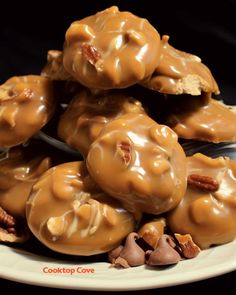 a white plate topped with lots of caramel covered donuts and pecan chips