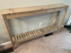 a wooden shelf sitting on top of a carpeted floor