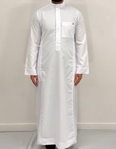 Introducing our Men's Oxford Fabric Saudi Thobe, the perfect addition to your Islamic clothing collection. Made from a high-quality Oxford Fabric, this thobe is not only easy to iron but also incredibly soft and comfortable to wear. The meticulous stitching make this thobe a truly stand-out piece. Available in a wide range of colours and sizes, you're sure to find the perfect fit for your personal style. And for the younger members of your family, we also offer this Saudi thobe in boys sizes. Wh Casual Cotton Thobe With Long Sleeves, White Long Sleeve Thobe For Eid, Festive White Embroidered Thobe, Luxury Long White Thobe, Traditional White Formal Thobe, Casual Long Sleeve Cotton Thobe, White Embroidered Long Thobe, Traditional White V-neck Thobe, Casual White Long Sleeve Thobe