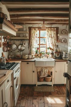 a kitchen with wooden floors and white cabinets, an old fashioned stove top oven and dishwasher