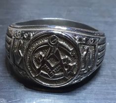 This SZ 10 Masonic Ring is made from sterling silver. Silver content is always verified before being listed.  Yes we are sure it's silver. Jewlery can also be verified again after delivery with your local jeweler. Classic Silver Signet Ring With Maker's Mark, Classic Silver Engraved Ring For Collectible, Symbolic 925 Stamped Engraved Ring For Formal Occasions, Adjustable Silver Engraved Ring With Hallmarks, Symbolic Engraved Ring For Formal Occasions, Formal Silver Stamped Signet Ring, Symbolic Silver Engraved Ring For Formal Occasions, Formal Antique Silver Hallmarked Ring, Silver Symbolic Ring For Formal Occasions