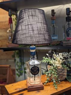 a lamp that is sitting on top of a table next to a vase with flowers