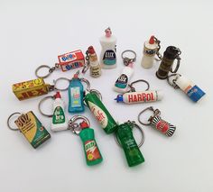 a bunch of different items that are on a white surface with one keychain