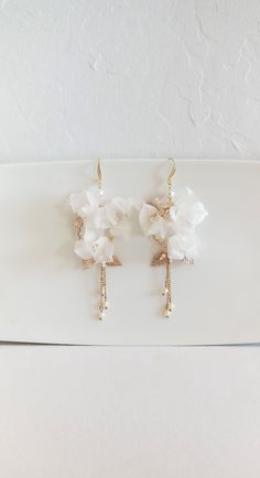 "GOLD FLORAL WEDDING EARRINGS Beautiful feminine long floral earrings for a modern bridal look. They are designed in a beautiful floral pattern with gorgeous hand made in Italy pure silk flowers, crystals and long dangling crystal pearls made in Austria. They are very light weight and easy to wear. They are available for pierced ears only. ♥ COLOR: Gold color metal with off-white silk flowers, clear crystals & white pearls ♥SIZE: Approximately 4 1/4\" long by 2\" wide ♥ WEIGHT: .2 ounces (5g Gold Dangle Flower Earrings For Wedding, Party Bridal Drop Earrings With Flower Decoration, White Linear Earrings For Wedding, Handmade Flower Gold Jewelry For Wedding, Elegant Bridal Earrings With Handmade Gold Flowers, Gold Bridal Drop Earrings With Flower Decoration, Elegant Gold Bridal Earrings With Handmade Flowers, Gold Wedding Jewelry With Handmade Flowers, Delicate White Linear Earrings