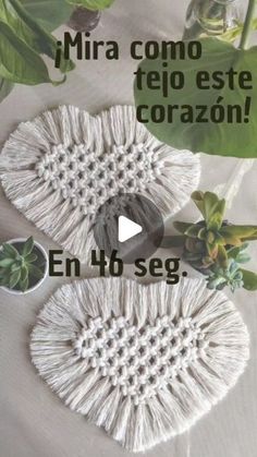 two crocheted shoes sitting on top of a table next to plants and flowers