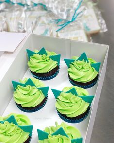 cupcakes with green frosting in a white box