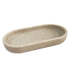 an oval dish with a ribbed pattern on the bottom and sides, in beige