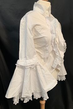 This is a stunning off white cotton shirt. It has bell cuffs and is fitted. It has lace trimming please refer to photos. This is a Uk Sm 10/12 upto chest 36". Victorian Cotton Fitted Blouse, Fitted Victorian Cotton Blouse, White Fitted Victorian Blouse, Fitted White Victorian Blouse, Fitted White Shirt With Ruffles, Victorian Long Sleeve Cotton Blouse, Fitted Cotton Blouse With Lace Sleeves, Fitted Victorian Ruffle Top, Spring Victorian Fitted Blouse