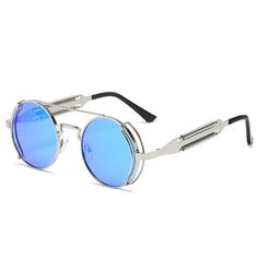 These Dani Joh sunglasses are the perfect. The Sunglasses are equipped with blue circle lens sunglasses. These circle will allow you to truly add a piece of perfection to your sunglass collection. Enjoy these exclusive sunglasses and show us how you'll rock them by using the hashtag #ShopDaniJoh. Sunglasses Features: Exclusive Round Sunglasses Polarized Blue Transparent Lens Metal frame design UV Protection Polycarbonate Lens One Size Sizing: 140mm x 50mm Trendy Silver Round Frame Sunglasses, Trendy Round Sunglasses For Outdoors, Trendy Round Sunglasses For Outdoor, Trendy Round Sunglasses For Outdoor Use, Blue Round Frame Sunglasses With Mirrored Lenses, Retro Blue Sunglasses For Outdoors, Blue Retro Sunglasses For Outdoor, Retro Blue Sunglasses For Outdoor, Trendy Blue Aviator Sunglasses For Outdoor